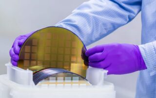 Silicon Wafer with semiconductors in clean room.