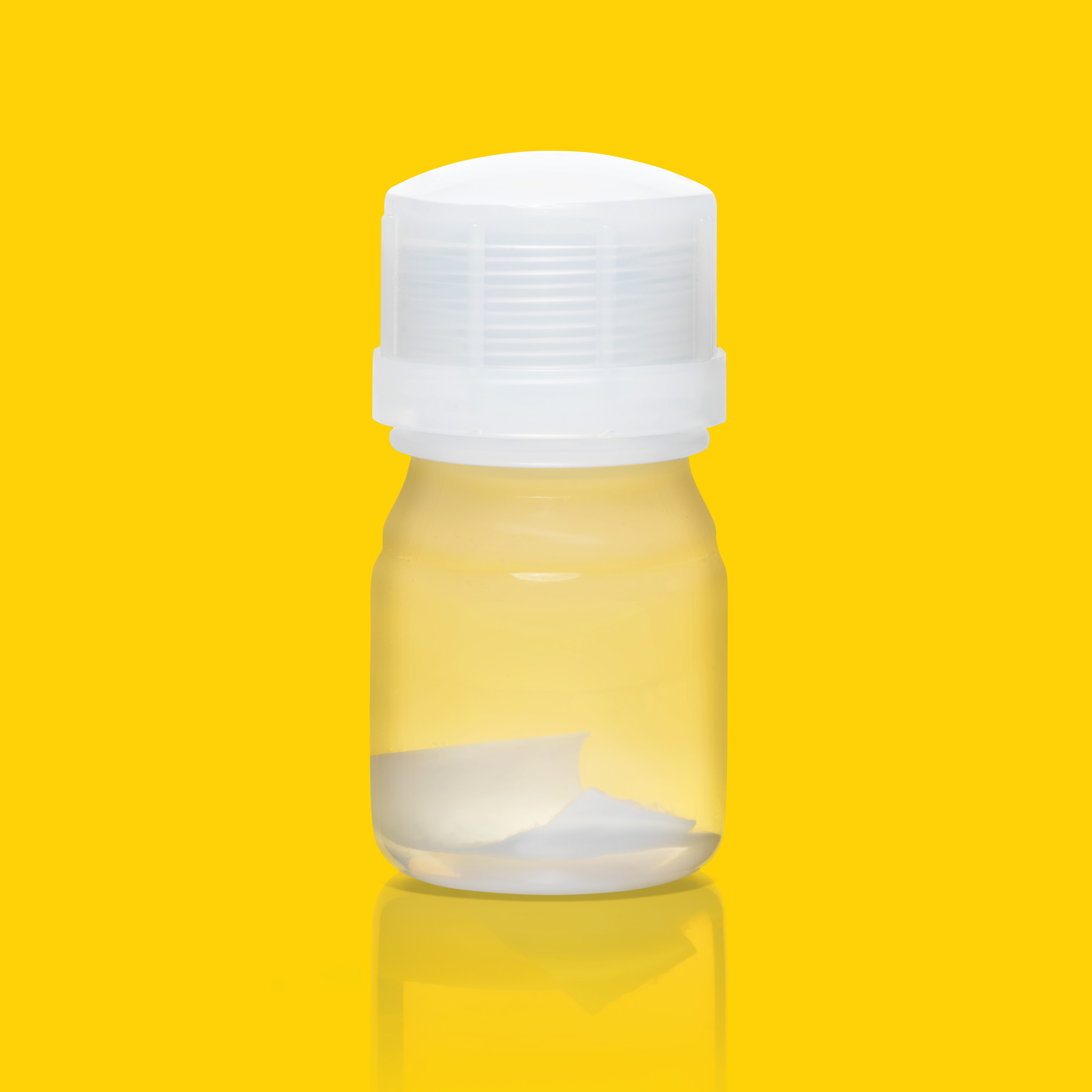 MACI bottle - no label. On yellow background.